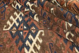 Close-up detail of 1900s Antique Carpets rug from Uzbekistan showing Wool weave