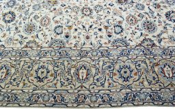 Corner detail of 2000s Kashan rug showing border pattern and Wool pile
