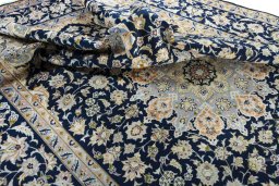 Surface texture of 2000s Najafabad rug with natural Wool and intricate pattern