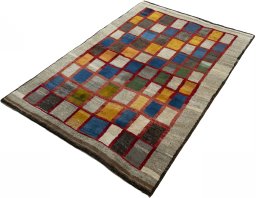 Corner detail of 2000s Persian Gabbeh rug showing border pattern and Wool pile