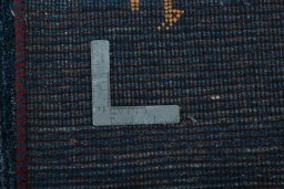 Corner detail of New Persian Gabbeh rug showing border pattern and Wool pile