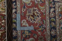Backside of handmade 2000s Tabriz 50/60/70 Raj rug showing knot structure and weave density