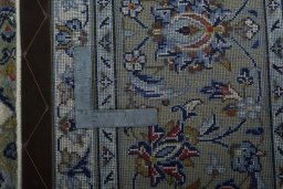 Backside of handmade 2000s Kashan rug showing knot structure and weave density