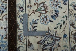 Backside of handmade 2000s Nain rug showing knot structure and weave density