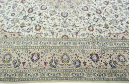 Corner detail of 2000s Kashan rug showing border pattern and Wool pile