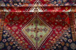 Full view of 2000s Shiraz rug from Iran / Persia, 175 × 110 cm in Red tones