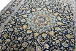 Backside of handmade 2000s Kashan rug showing knot structure and weave density
