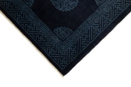 Backside of handmade 1990s China rug showing knot structure and weave density