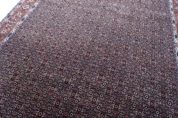 Backside of handmade New Bijar rug showing knot structure and weave density
