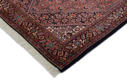 Backside of handmade New Bijar rug showing knot structure and weave density