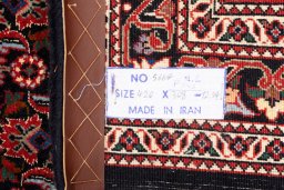 Backside of handmade New Bijar rug showing knot structure and weave density