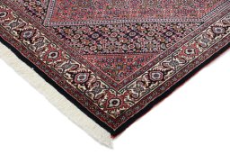 Backside of handmade New Bijar rug showing knot structure and weave density