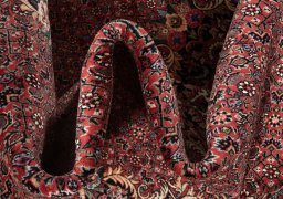 Backside of handmade New Bijar rug showing knot structure and weave density