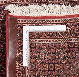 Backside of handmade New Bijar rug showing knot structure and weave density