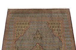 Surface texture of 1960s Ghom rug with natural Wool and intricate pattern