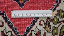 Backside of handmade 1990s Ghom rug showing knot structure and weave density