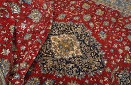 Backside of handmade 1970s Ghom rug showing knot structure and weave density