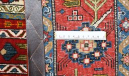 Corner detail of 1950s Ghom rug showing border pattern and Wool pile