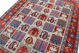 Backside of handmade 1950s Ghom rug showing knot structure and weave density