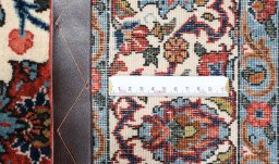 Corner detail of 1950s Ghom rug showing border pattern and Wool pile