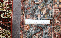 Close-up detail of 1950s Ghom rug from Iran / Persia showing Wool weave