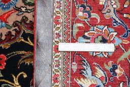 Backside of handmade 2000s Ghom rug showing knot structure and weave density