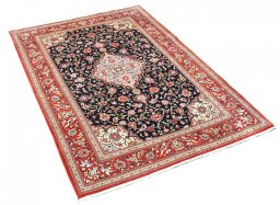 Corner detail of 2000s Ghom rug showing border pattern and Cork pile
