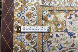 Surface texture of 2000s Ghom rug with natural Cork and intricate pattern