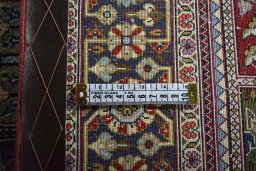 Corner detail of 2000s Ghom rug showing border pattern and Wool pile