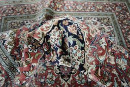 Surface texture of 1970s Ghom rug with natural Silk and intricate pattern
