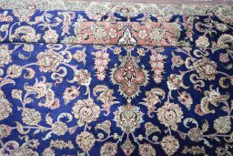 Surface texture of 2000s Ghom rug with natural Silk and intricate pattern