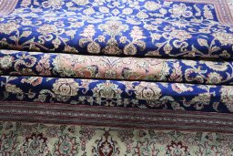 Backside of handmade 2000s Ghom rug showing knot structure and weave density