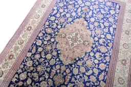 Backside of handmade 2000s Ghom rug showing knot structure and weave density