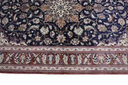 Corner detail of 2000s Ghom rug showing border pattern and Silk pile