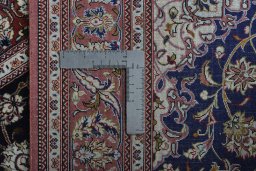 Backside of handmade 2000s Ghom rug showing knot structure and weave density
