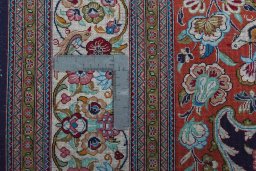 Backside of handmade 1970s Ghom rug showing knot structure and weave density