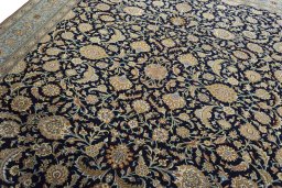 Backside of handmade 1950s Ghom rug showing knot structure and weave density