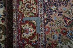 Backside of handmade 2000s Ghom rug showing knot structure and weave density
