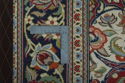 Backside of handmade 2000s Ghom rug showing knot structure and weave density