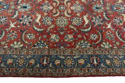 Corner detail of 1970s Ghom rug showing border pattern and Wool pile