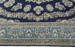 Corner detail of 2000s Ghom rug showing border pattern and Wool pile