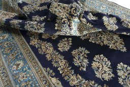 Surface texture of 2000s Ghom rug with natural Wool and intricate pattern