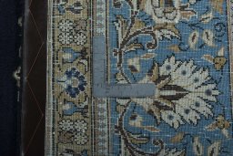 Backside of handmade 2000s Ghom rug showing knot structure and weave density