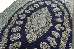 Backside of handmade 2000s Ghom rug showing knot structure and weave density