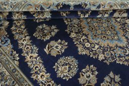 Close-up detail of 2000s Ghom rug from Iran / Persia showing Wool weave