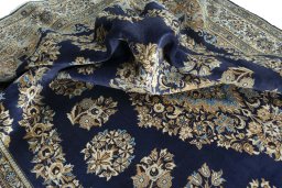 Surface texture of 2000s Ghom rug with natural Wool and intricate pattern