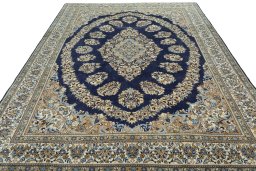 Surface texture of 2000s Ghom rug with natural Wool and intricate pattern