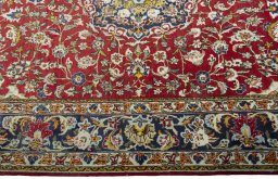 Corner detail of 2000s Ghom rug showing border pattern and Wool pile