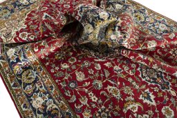 Surface texture of 2000s Ghom rug with natural Wool and intricate pattern