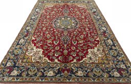Surface texture of 2000s Ghom rug with natural Wool and intricate pattern